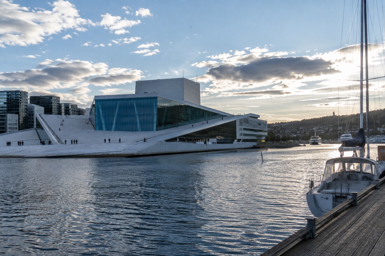 Oslo Opera House waterfront with fjord water and moored boats in morning light
