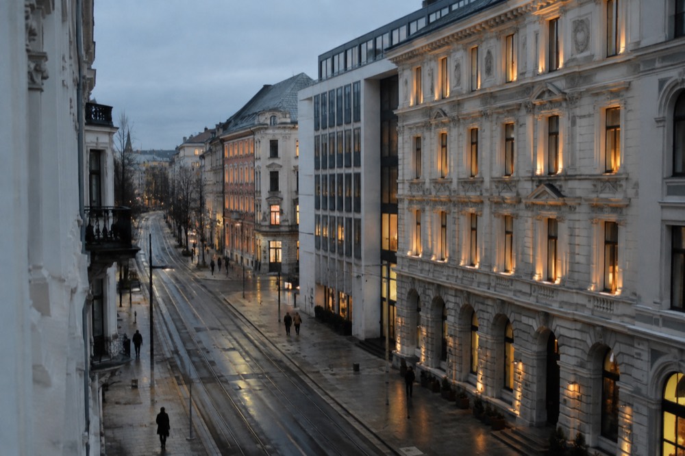 Lit historic building facade in central Oslo on a dark evening