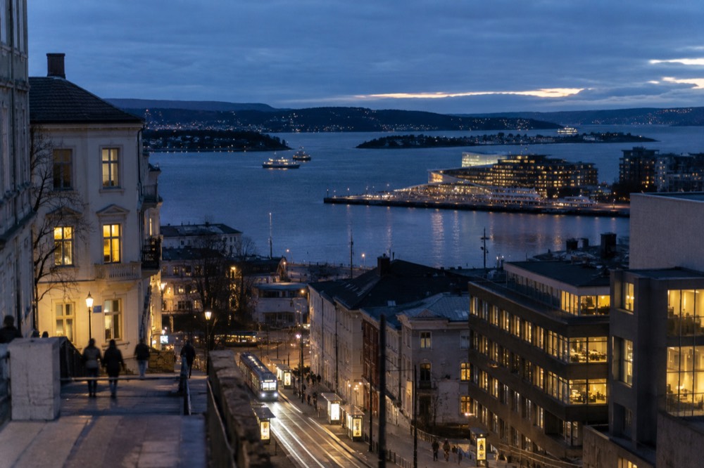 City lights of Oslo seen across dark water from the fjord