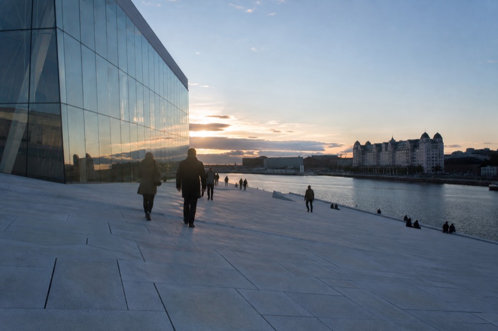 White marble Opera House roof with visitors walking on its sloping surface
