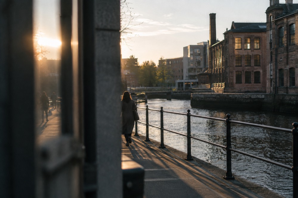 Old industrial brick buildings along a river in the Grünerløkka district
