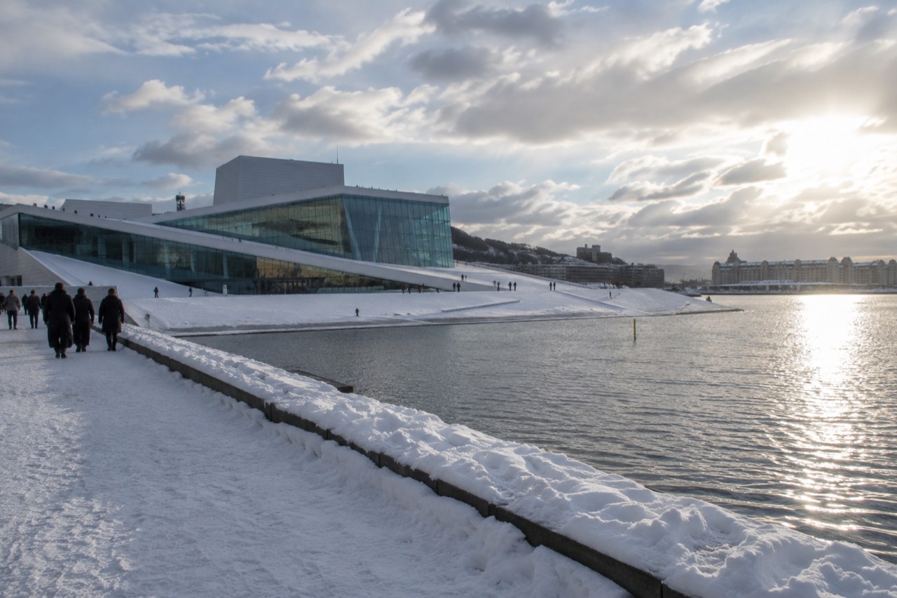 Snow-covered Oslo waterfront with the Opera House and fjord in winter light