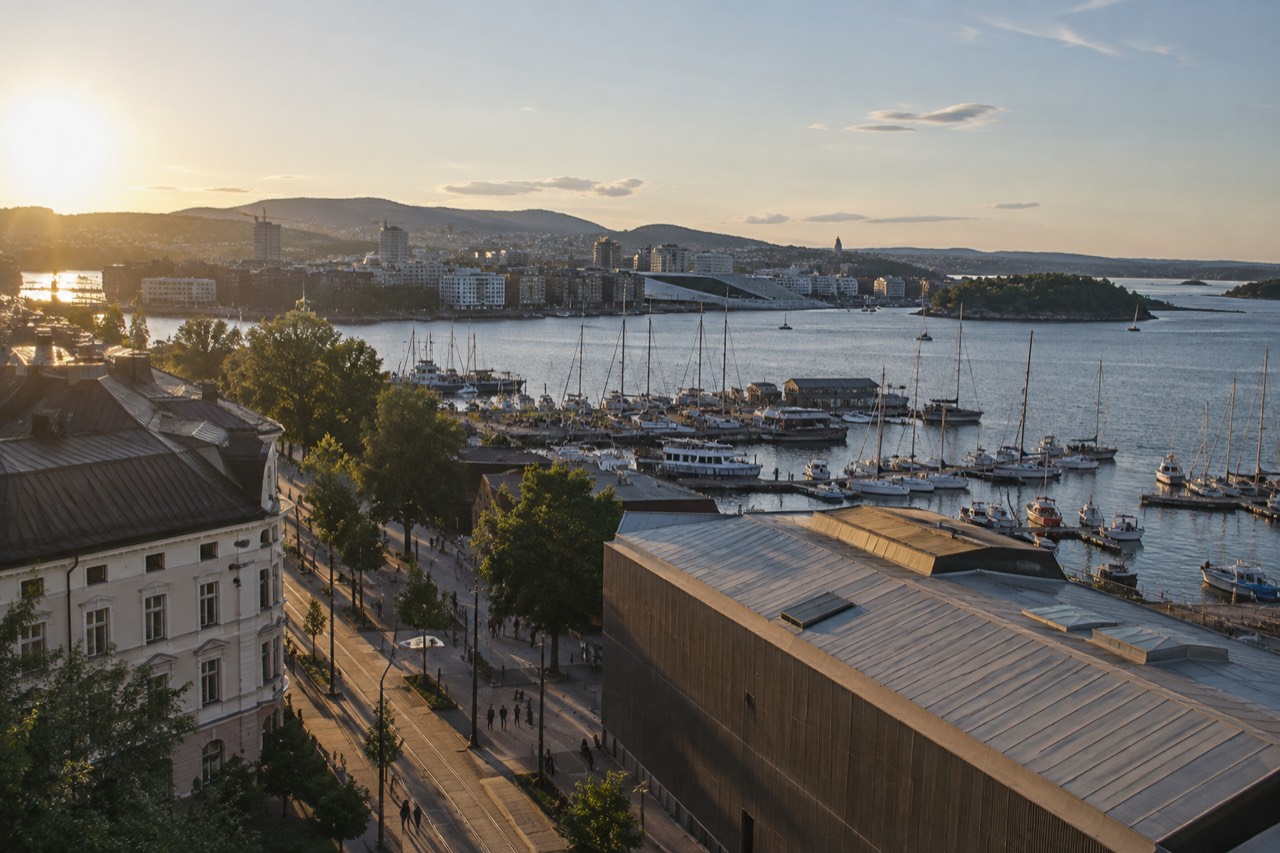 Sailboats moored in the Oslofjord on a bright evening with the city skyline behind