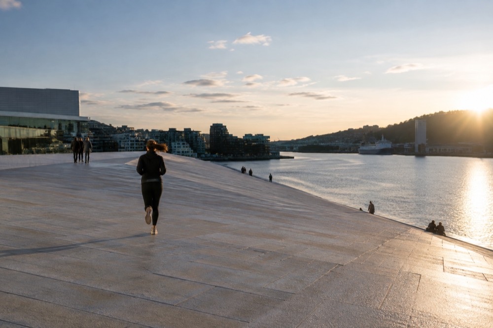 The Oslofjord waterfront with the Opera House roof in the foreground on a bright morning