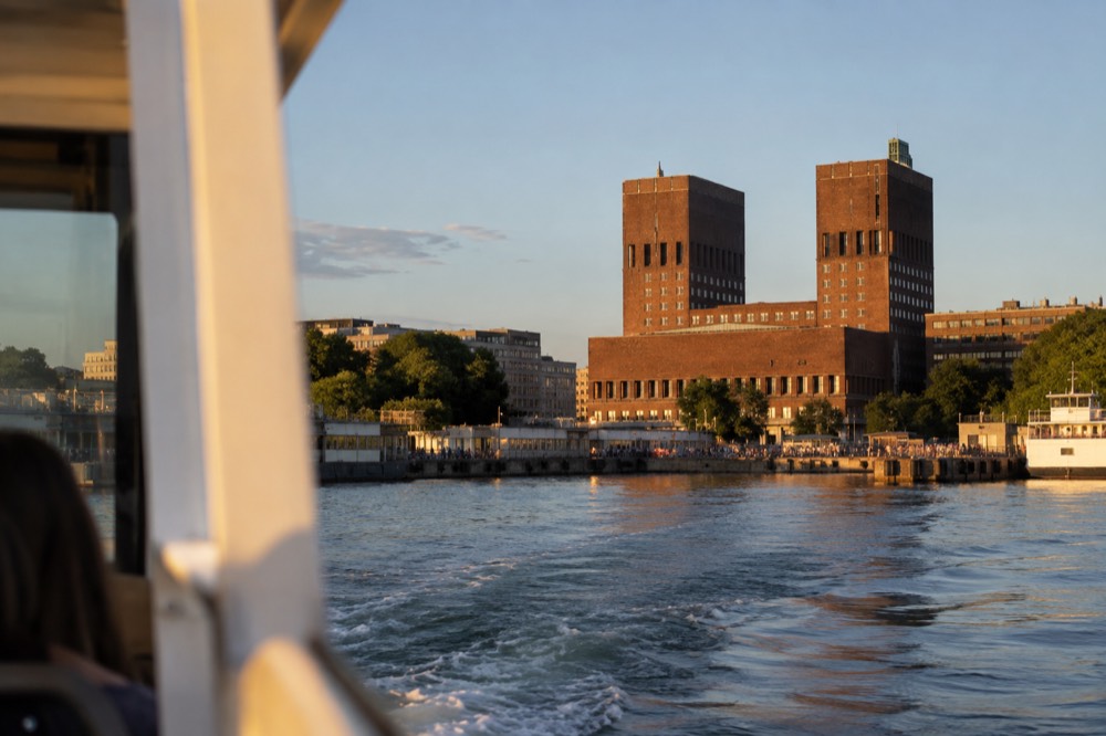 The passenger ferry leaving the City Hall pier toward the Bygdøy peninsula on a calm summer day