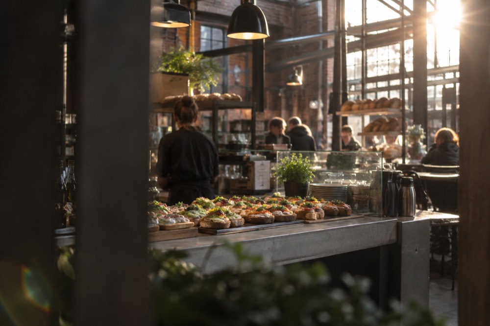 A food hall counter with open sandwiches and coffee in central Oslo