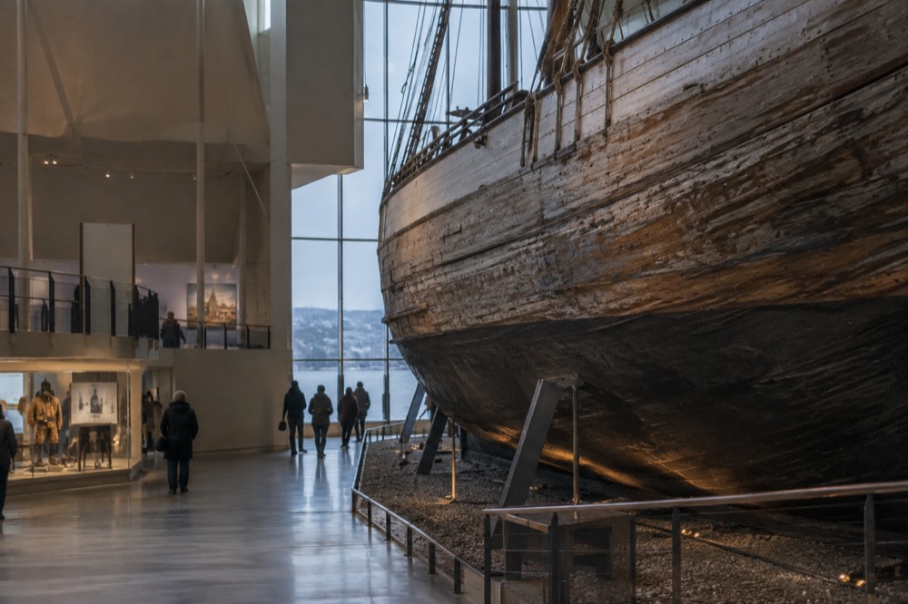 The interior of a polar exploration museum with a large wooden ship hull