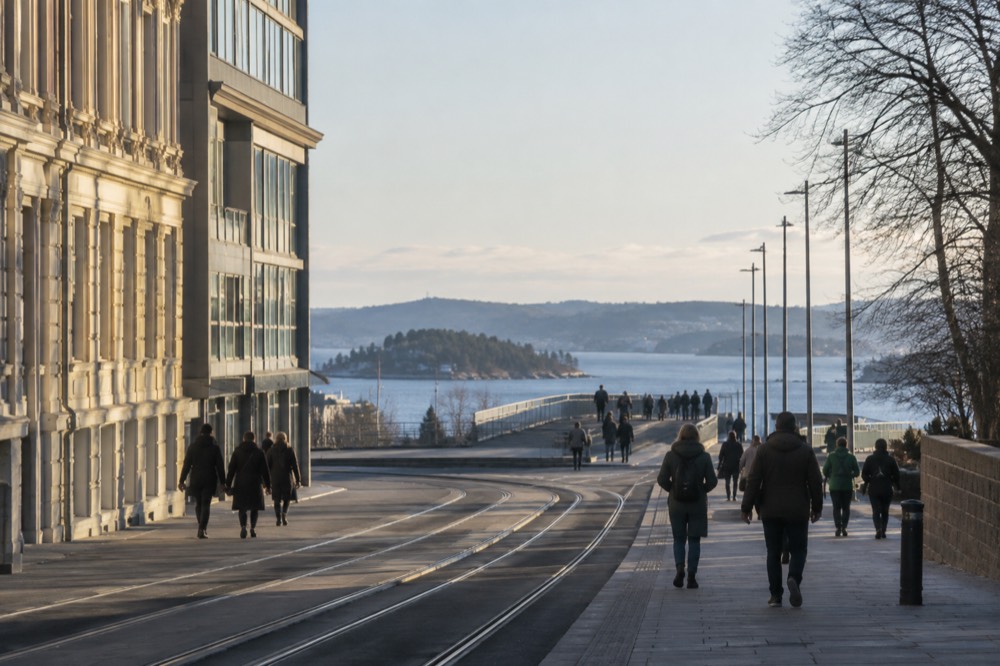 Walkers crossing a bridge toward small green islands in the Oslofjord