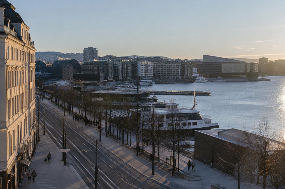 Oslo waterfront with moored boats and modern buildings under a bright sky