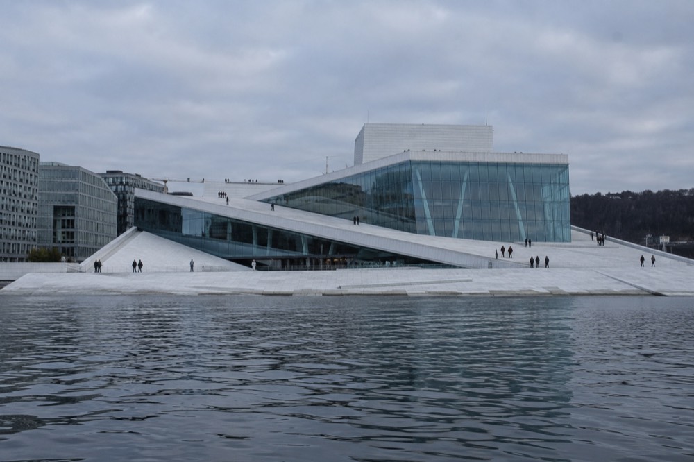 Sloping marble roof of the Oslo Opera House seen from the water
