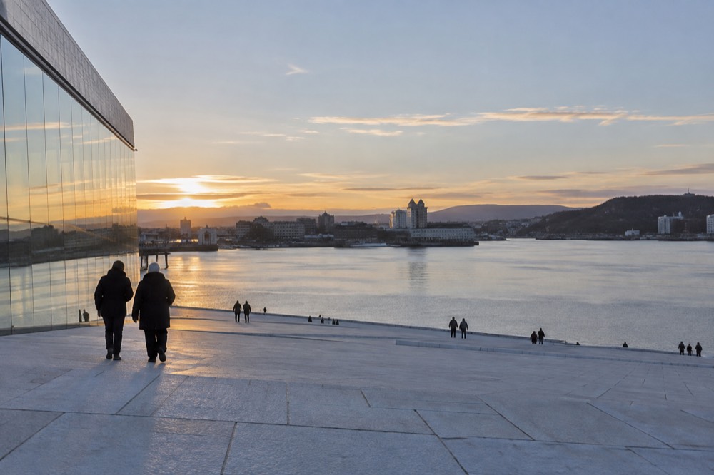 White marble roof of the Oslo Opera House sloping down to the fjord