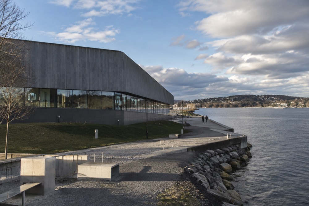 The massive wooden hull of a historic polar ship inside a dim museum hall