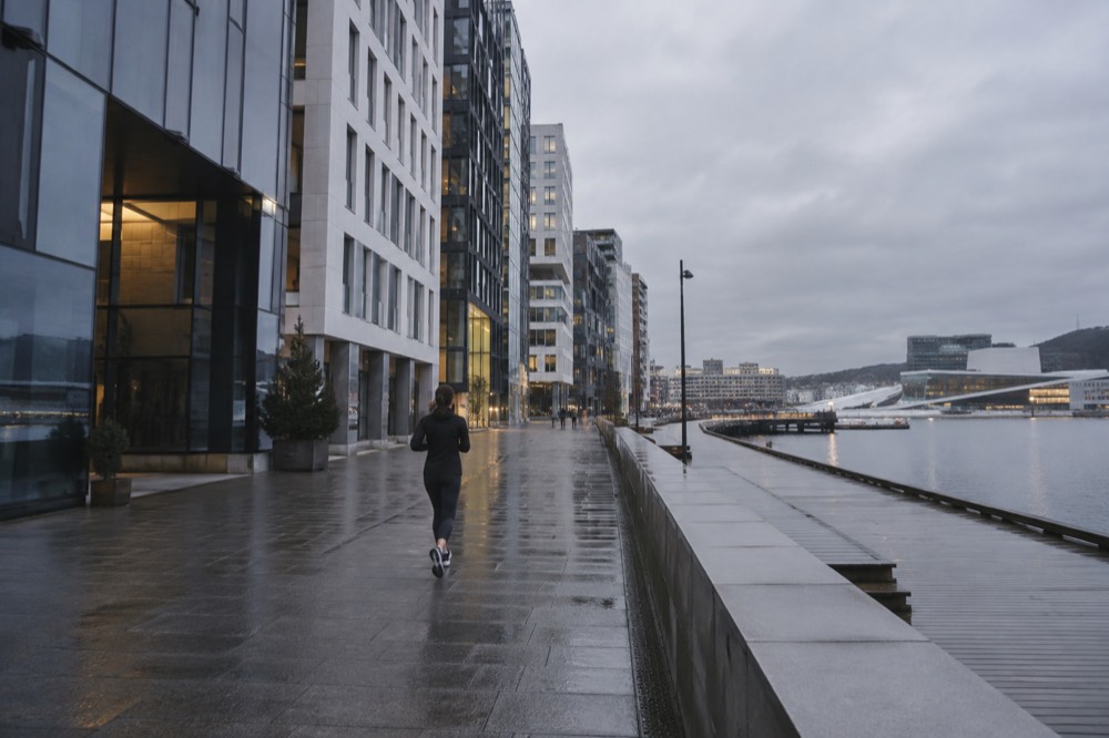 Rain-streaked windows overlooking the Bjørvika waterfront and museum buildings