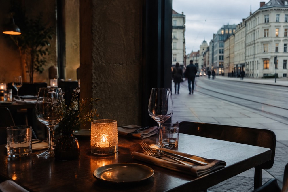 Candlelit table set for dinner in a small Oslo restaurant
