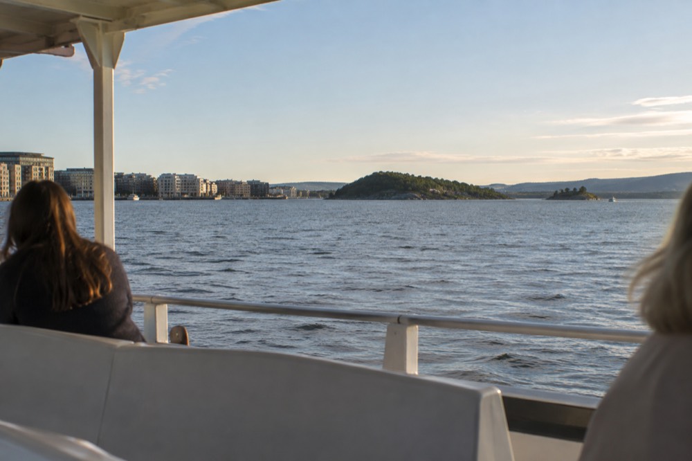 Electric passenger boat moving across the Oslofjord toward the islands