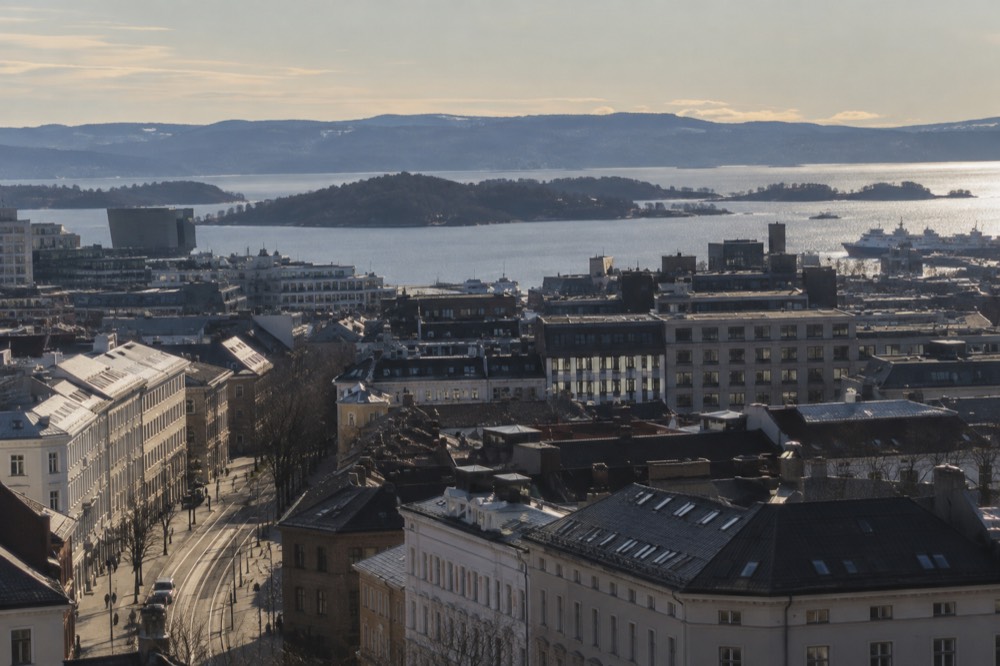 Aerial view of central Oslo with the fjord and surrounding forested hills